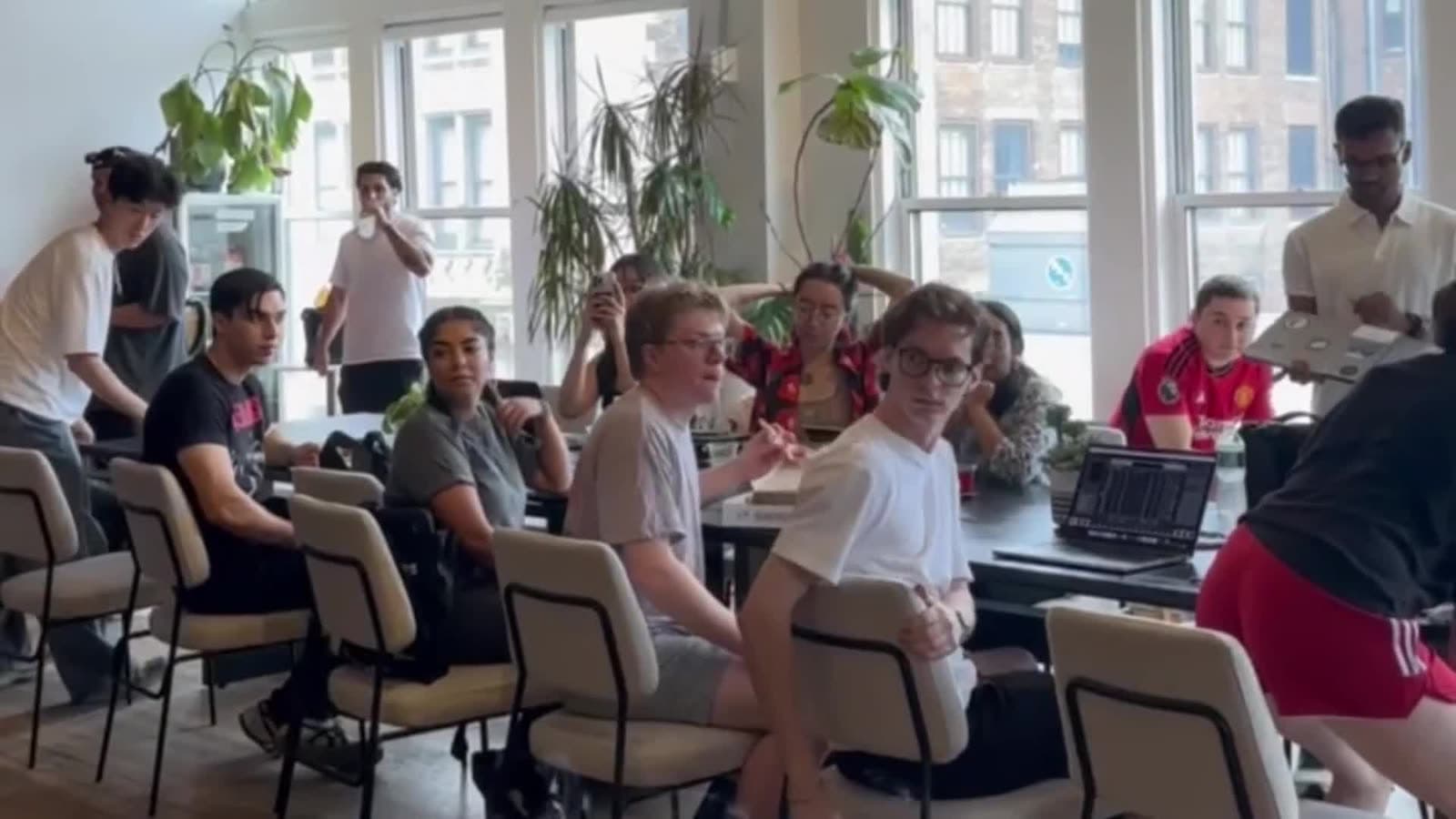 A bright room of members around a big table